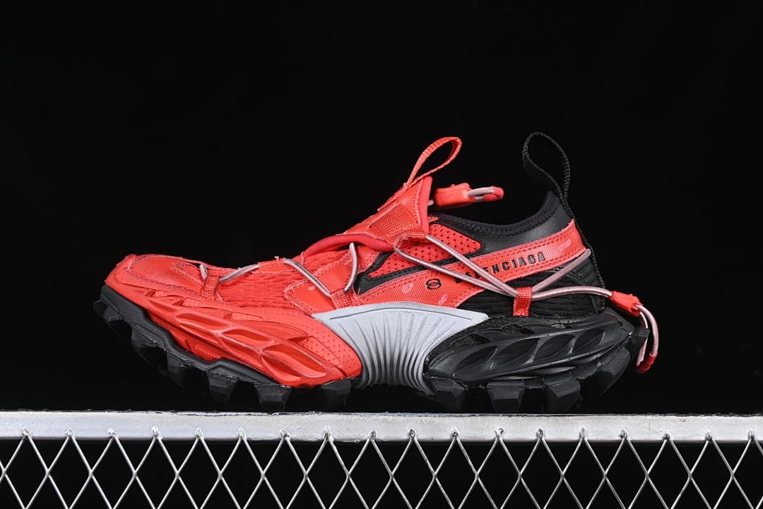 Side view of red and black Balenciaga Hike Trail low-top sneakers with a chunky lugged sole