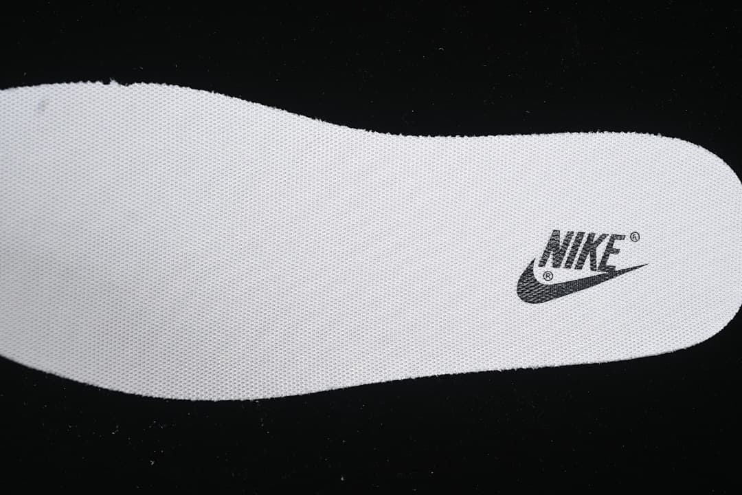 Textured shoe insert with a Nike logo.