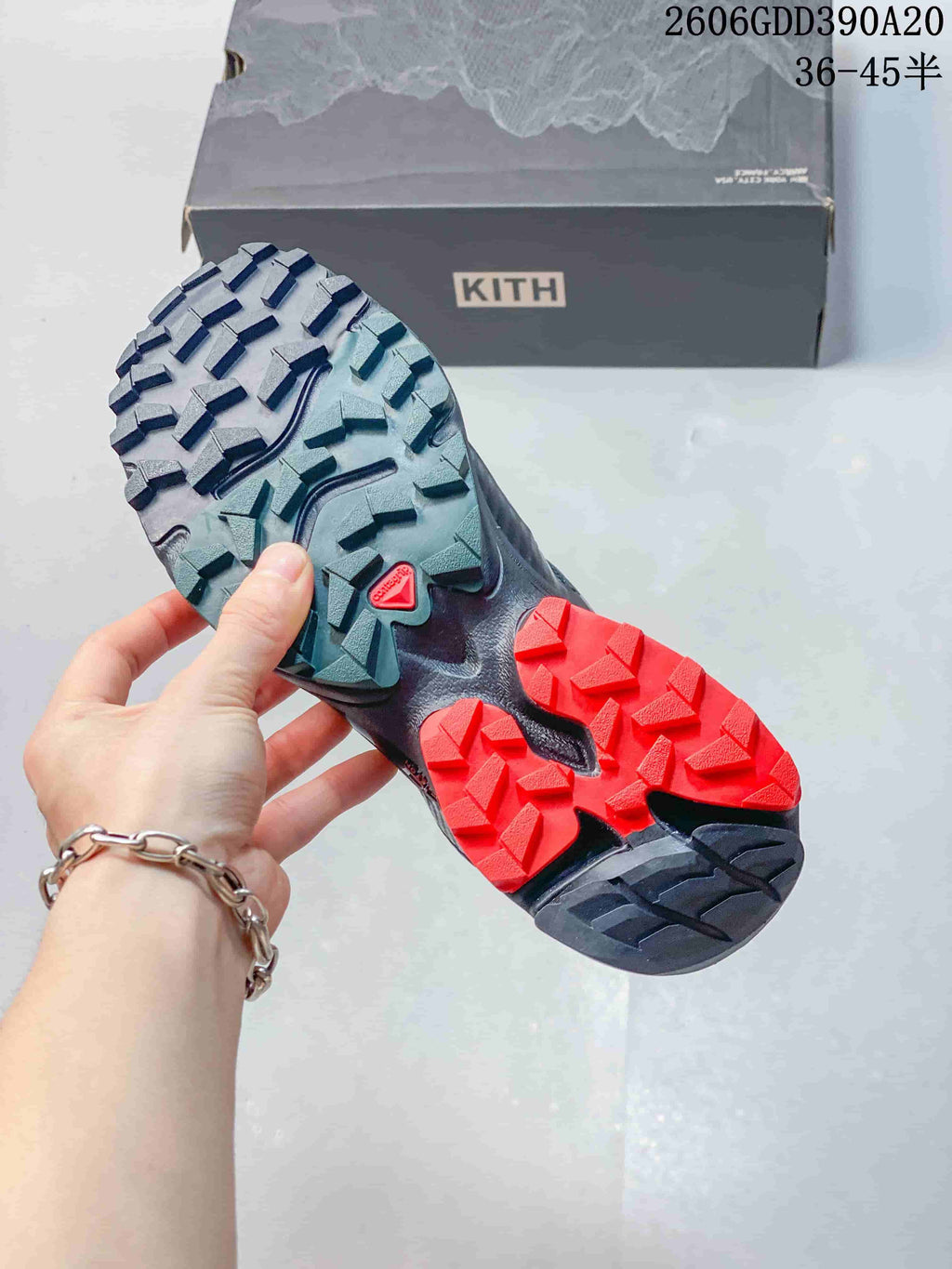 Close-up of the Salomon XT-4K shoe outsole with angular tread and red and teal sections.