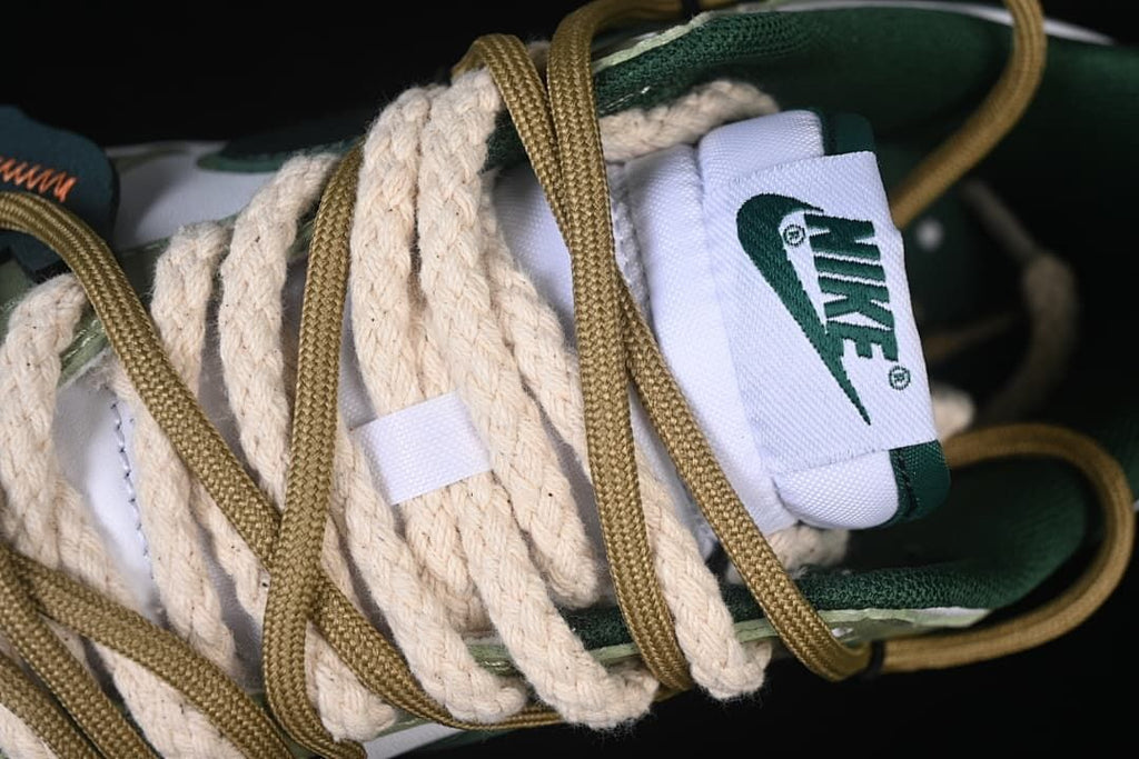 Close-up of layered cream and tan laces and the tongue label