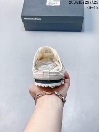 Rear view of a cream Onitsuka Tiger Mexico 66 Sabot sneaker held above its shoebox; the box shows the size range 36–45 and source code 2604JDY297A25.