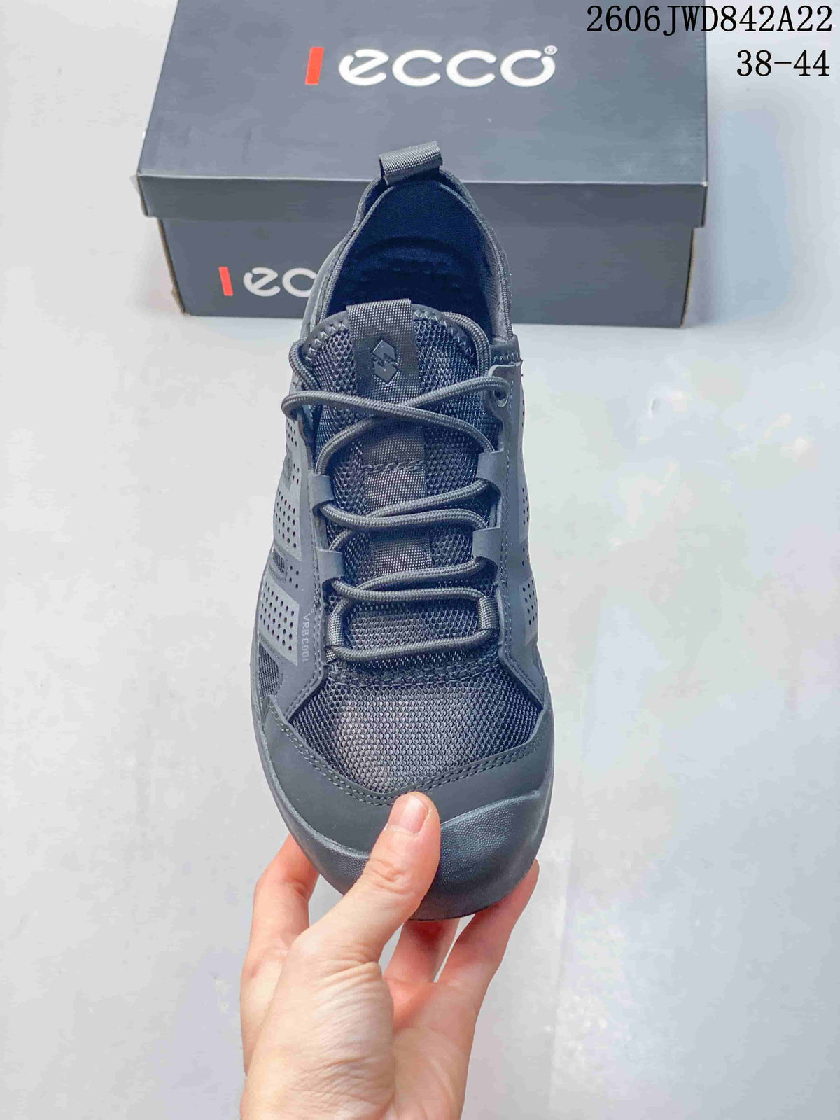 Top view of a gray sneaker showing its laces and mesh-look upper