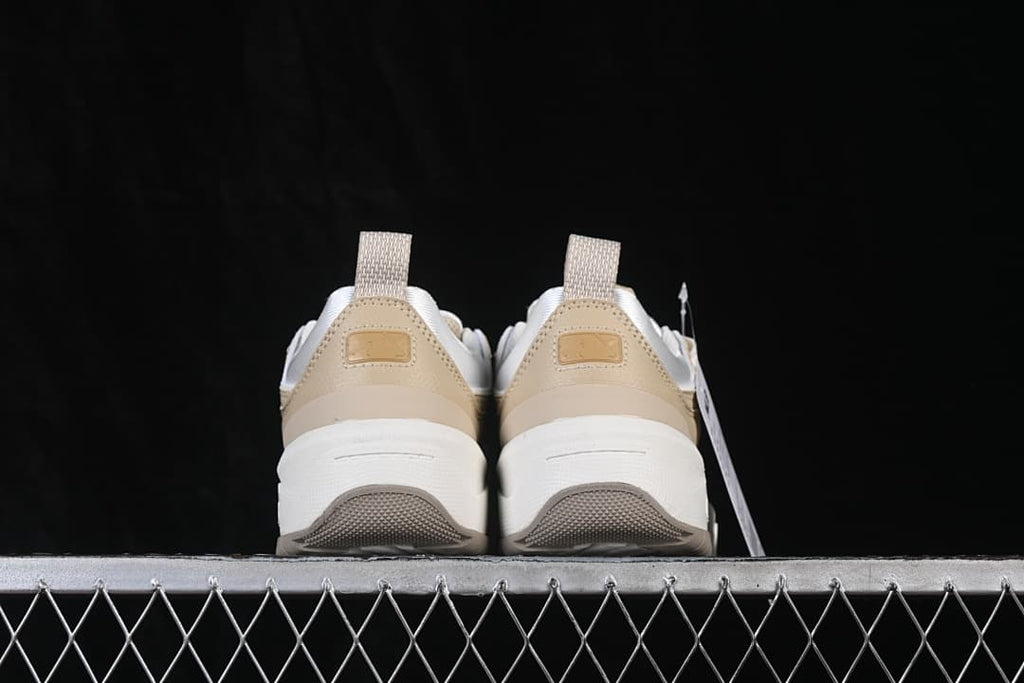 Rear view of both sneakers showing heel tabs and thick soles