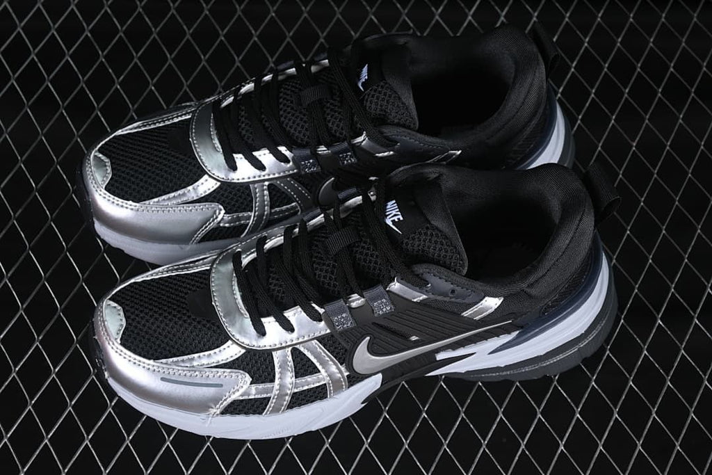 Pair of black, silver, and white low-top shoes viewed from above