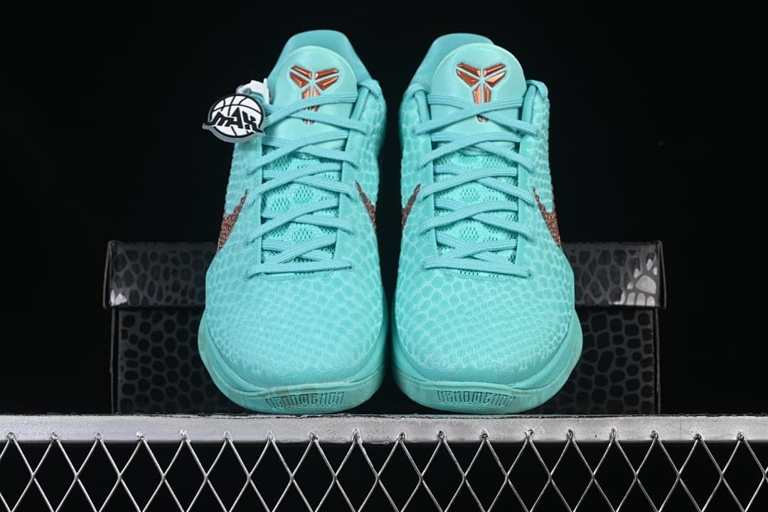 Front view of the pair with turquoise uppers and copper-toned tongue emblems.