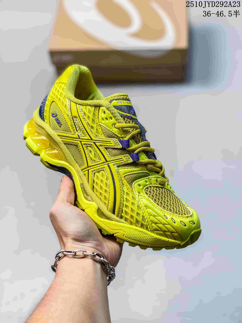 Bright yellow ASICS Gel-Nimbus sneaker with mesh panels and a matching sole.