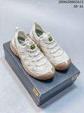 Pair of white and beige CAT lace-up sneakers displayed on a CAT shoe box
