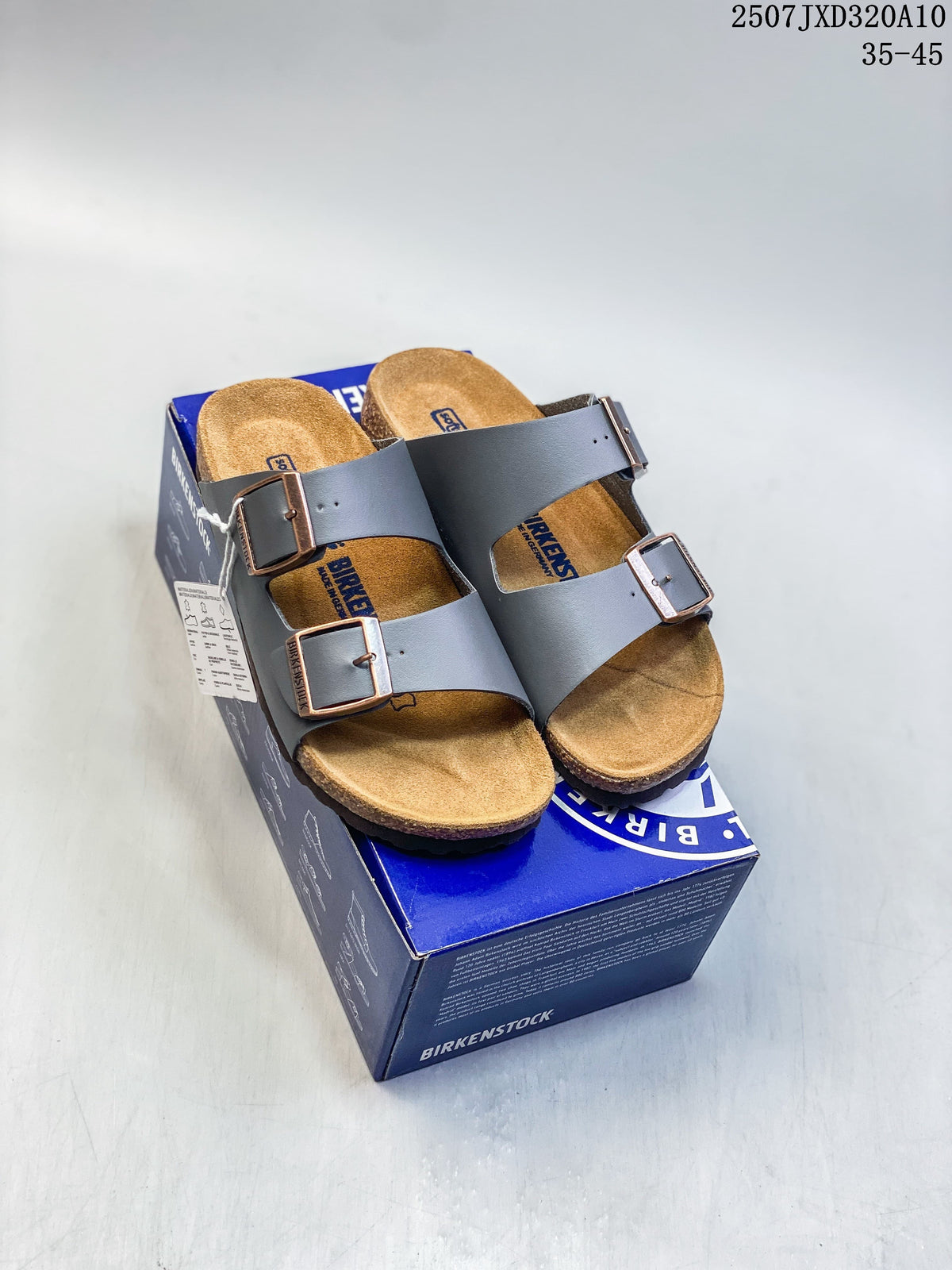 Pair of dark brown buckle-strap slide sandals photographed on a box