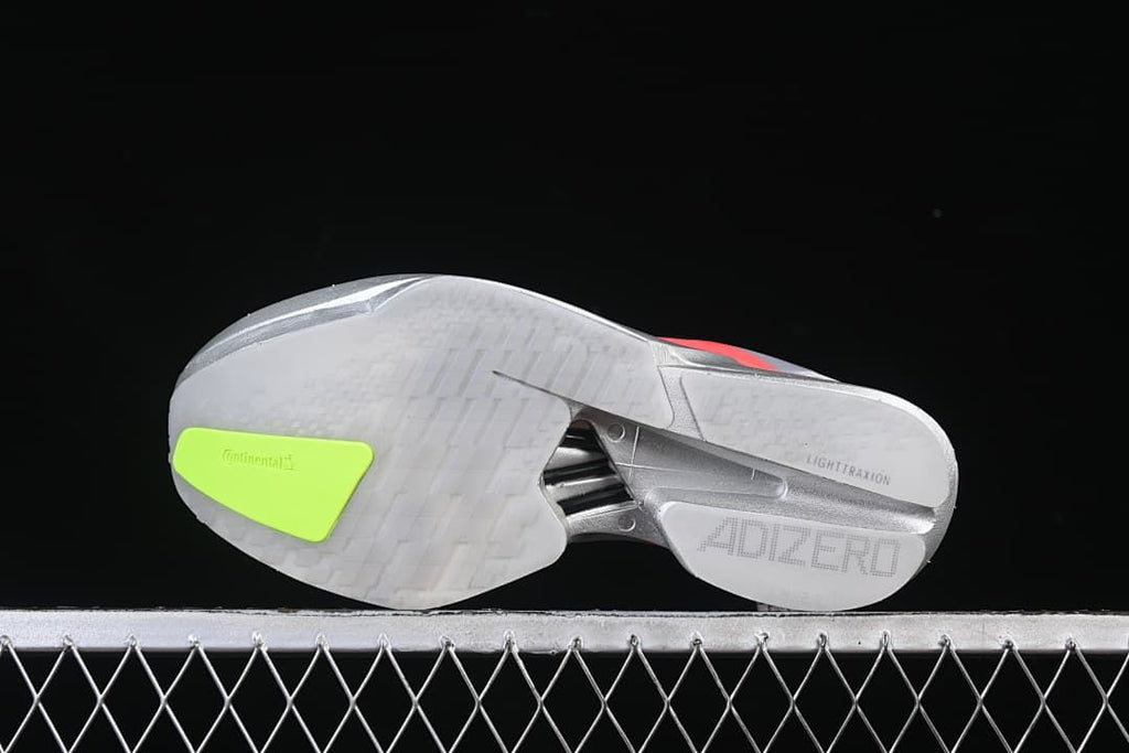 Outsole view showing tread, neon yellow-green insert and midfoot structure