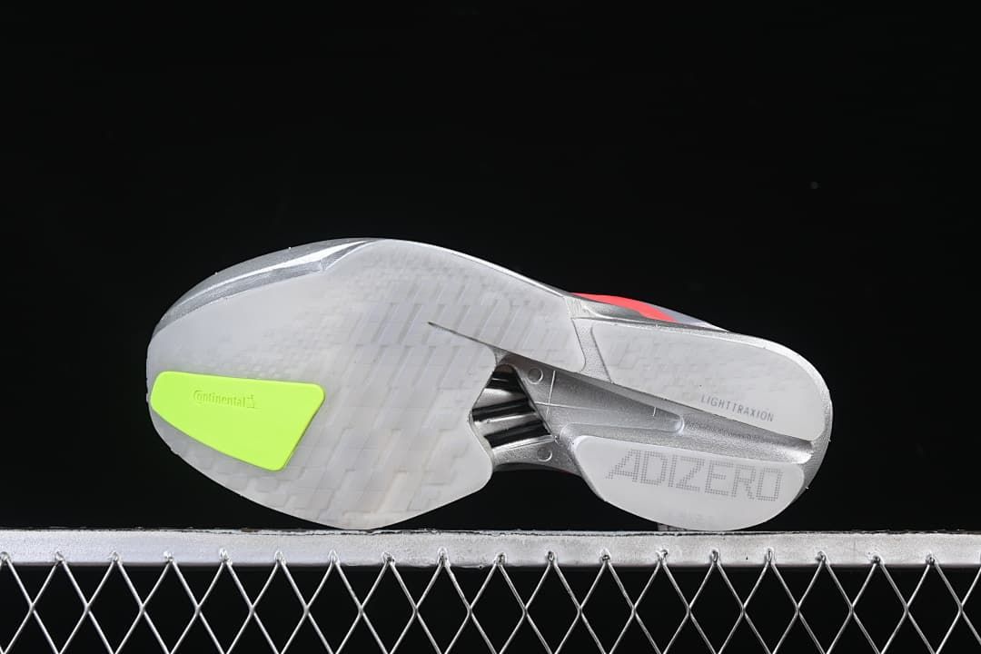 Outsole view showing tread, neon yellow-green insert and midfoot structure