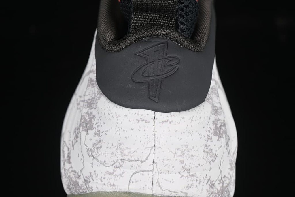 Rear view showing the patterned heel, black heel panel, and embossed logo.