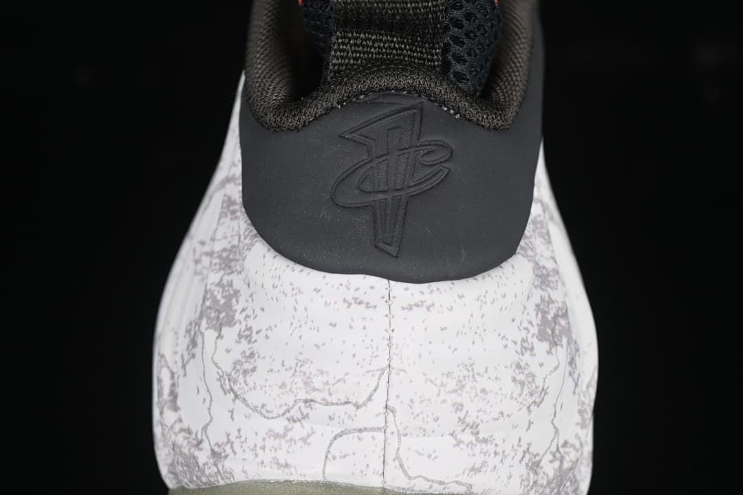 Rear view showing the patterned heel, black heel panel, and embossed logo.