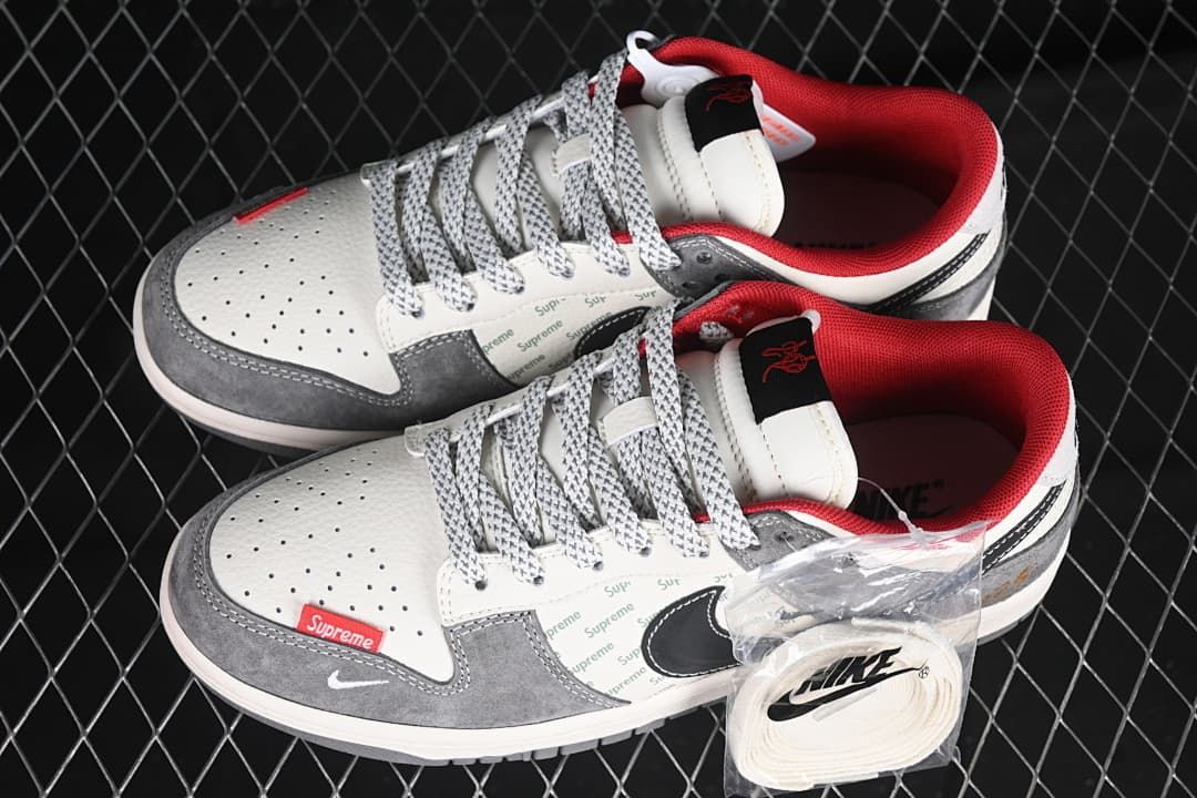 Pair of Nike Dunk Low sneakers with an additional set of white laces