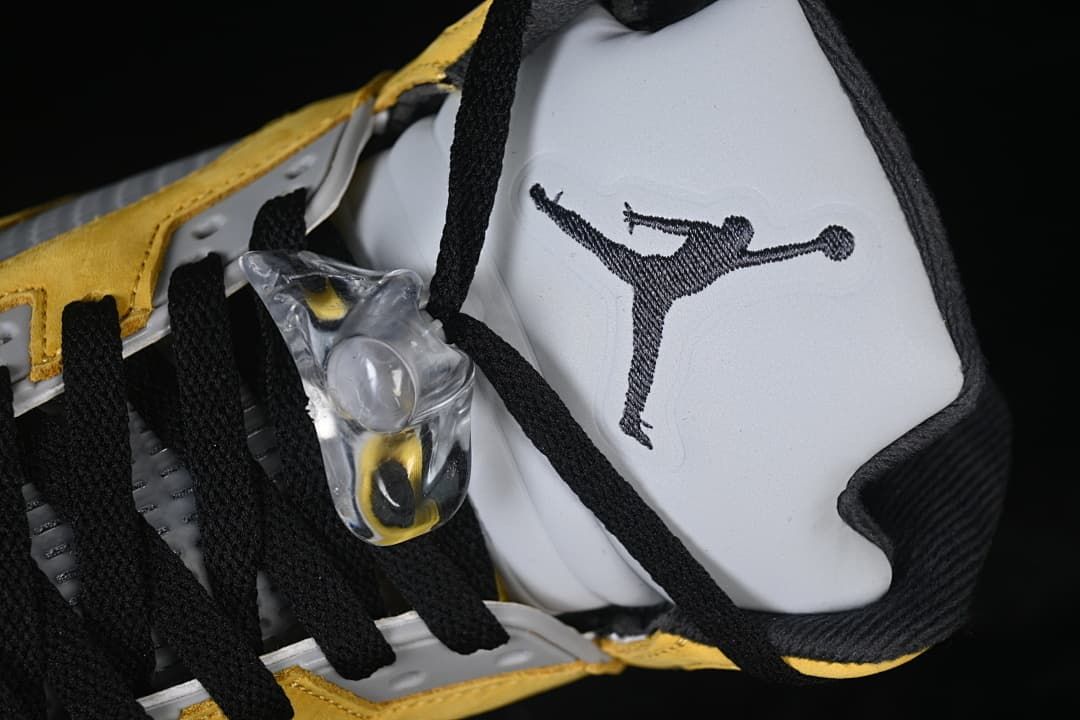 Close-up of the tongue logo, black laces, and translucent lace lock
