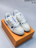 Pair of white and blue LV Trainer sneakers shown from the front on an orange box.
