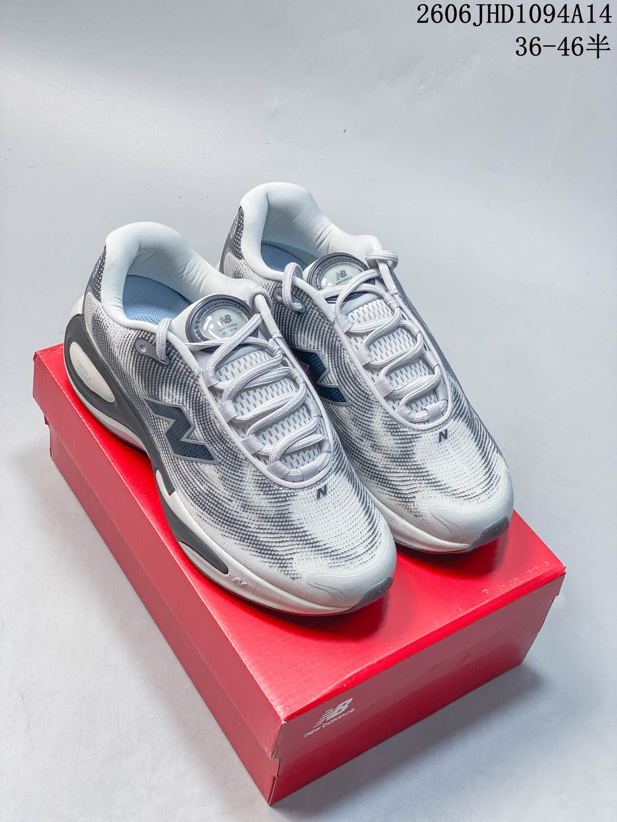 Light gray New Balance AC Runner shoes with dark patterned details, shown on a red shoebox.