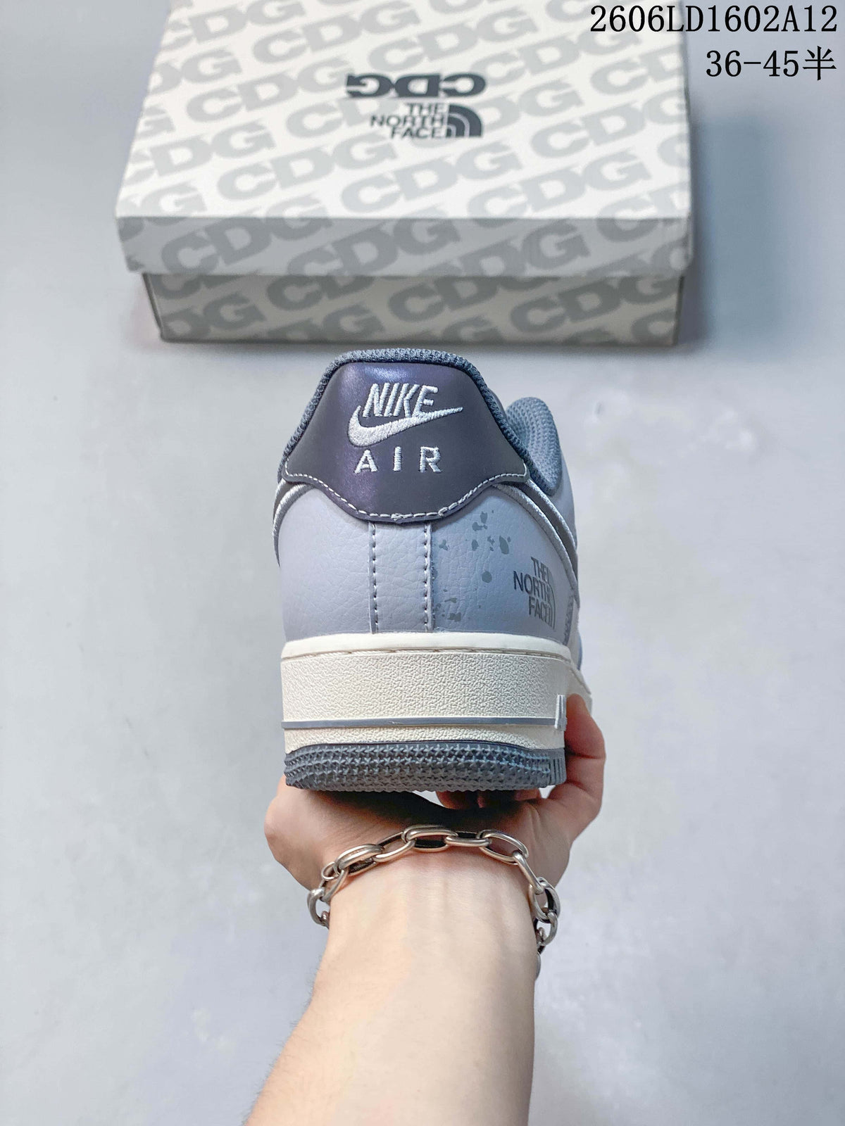 Rear view showing grey heel panels, speckled detailing, and logo marks.