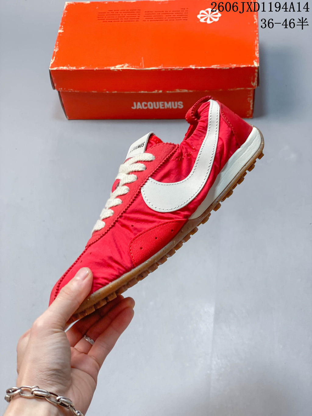 Side view of a red low-top sneaker with an off-white swoosh and gum outsole
