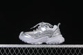 Side view of a silver and light gray chunky children’s sneaker