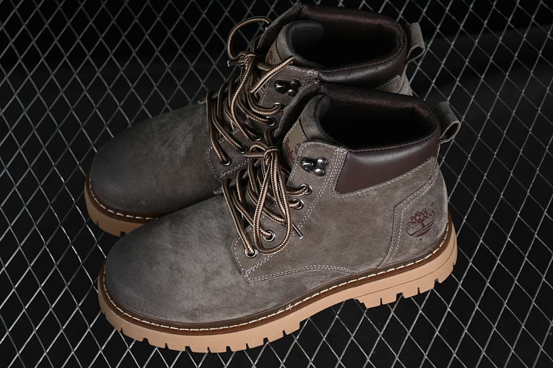 Pair of gray mid-top boots shown from an angled front view.