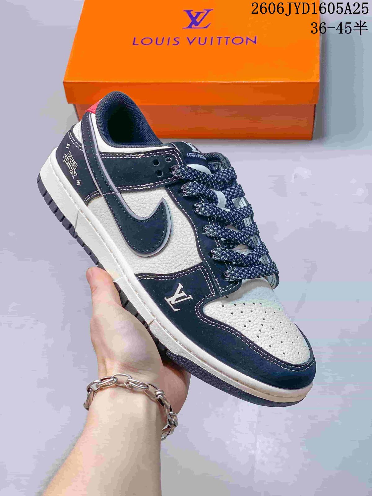 Low-top sneaker with navy and white panels, patterned laces, graphic detailing, and an orange box in the background