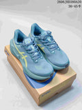 Blue ASICS Novablast 6 running shoes with yellow accents, shown from above on a shoe box