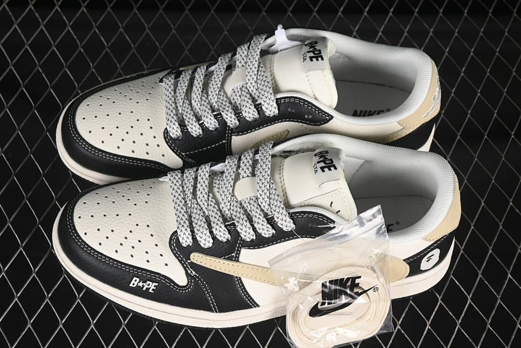 Top view of a pair of black and off-white low-top sneakers with patterned laces and an extra pair of light-colored laces.