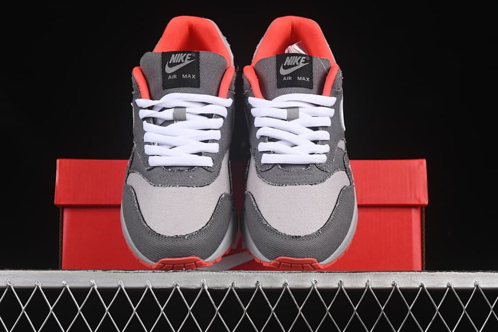 Front view of the pair showing grey panels, white laces, and crimson lining.
