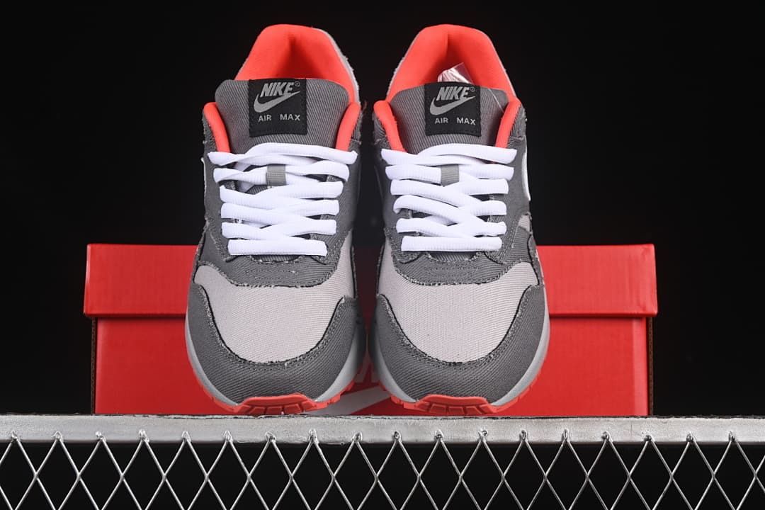 Front view of the pair showing grey panels, white laces, and crimson lining.