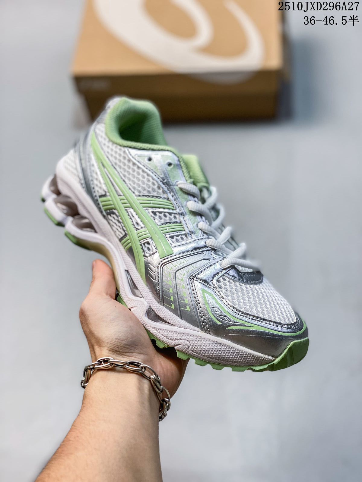 Silver and white mesh sneaker with pale green accents, held in hand.