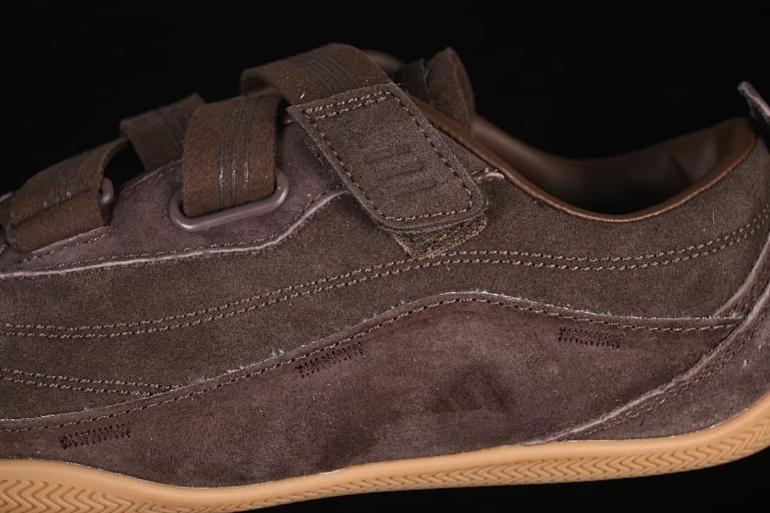 Side detail of the brown upper, stitching, and hook-and-loop strap.