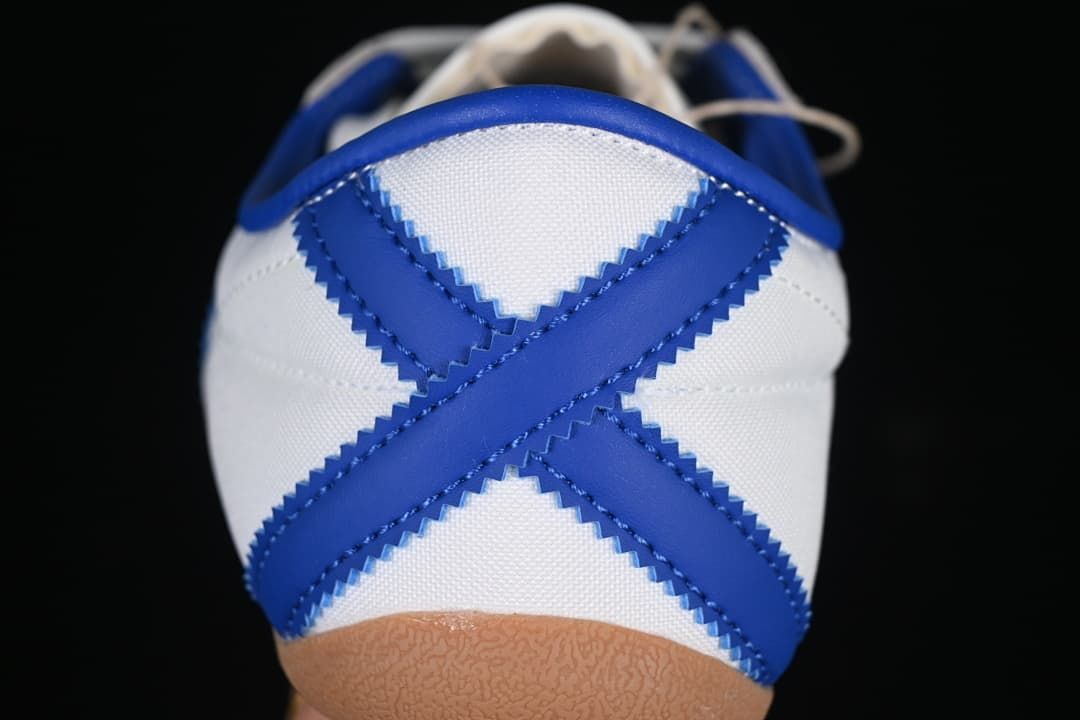 Rear view showing crossed blue heel stripes and gum outsole