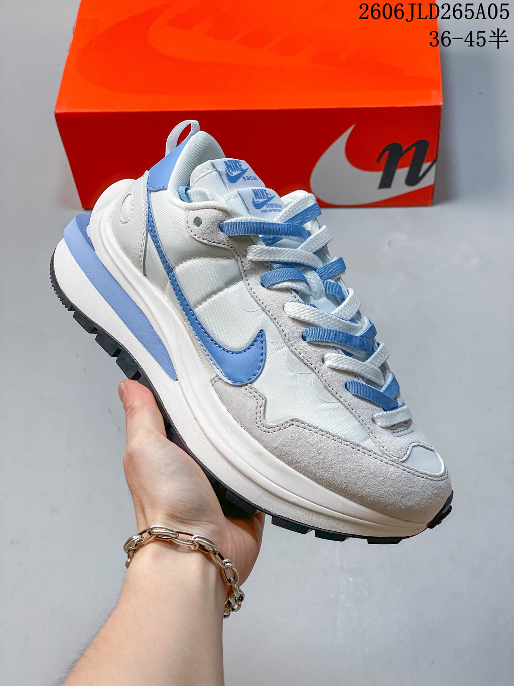 Angled side view of the Nike Sacai LDWaffle sneaker with blue accents