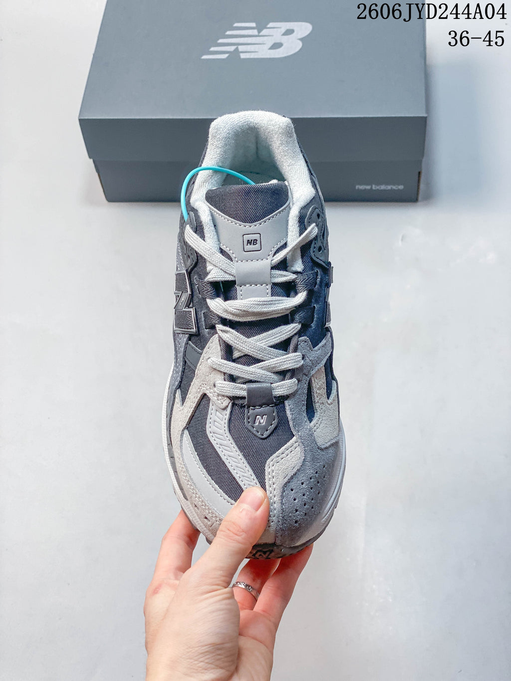 Top view of a gray New Balance 1906R sneaker showing its laces and overlays