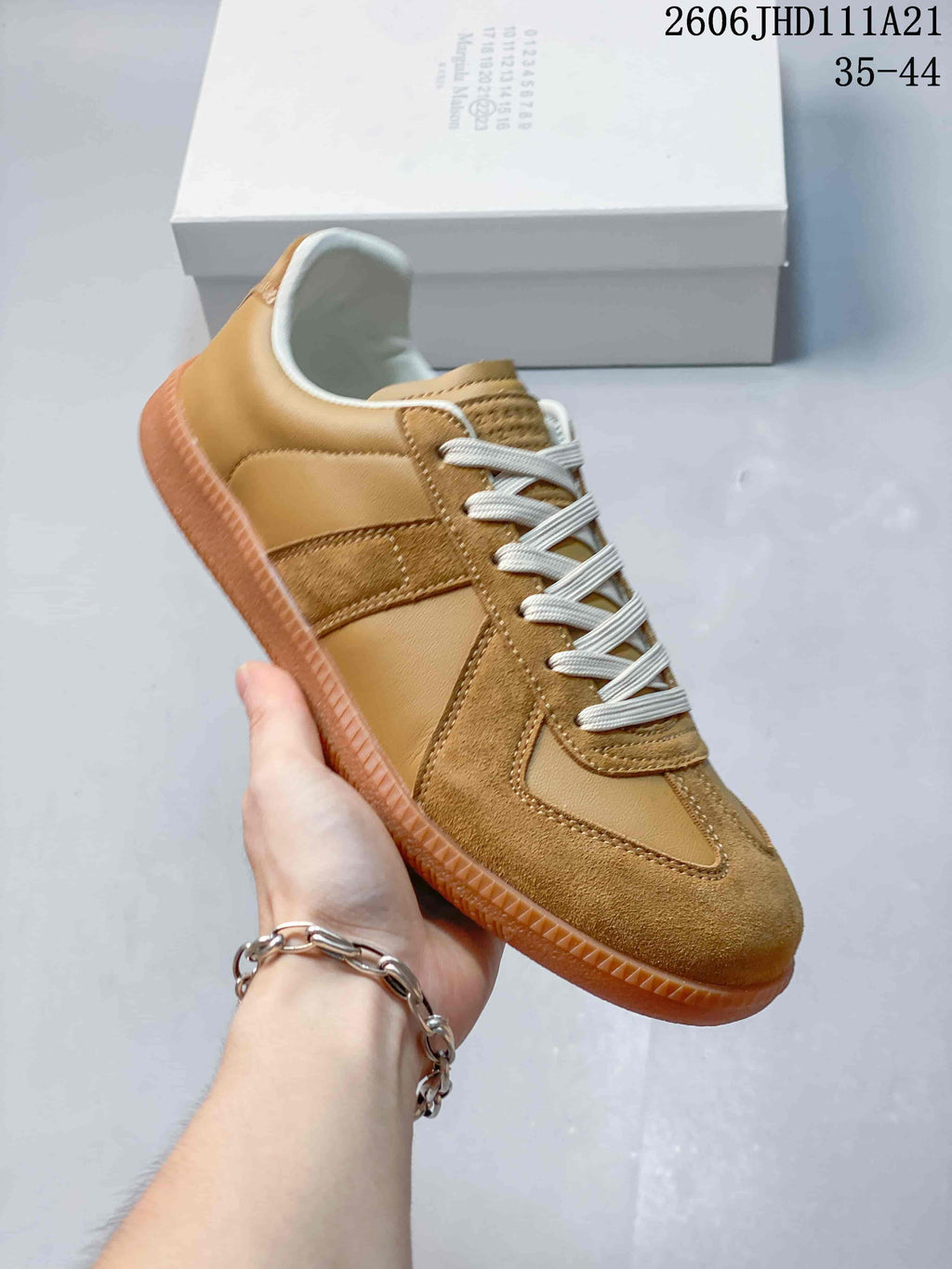 Angled side view of the tan low-top sneaker
