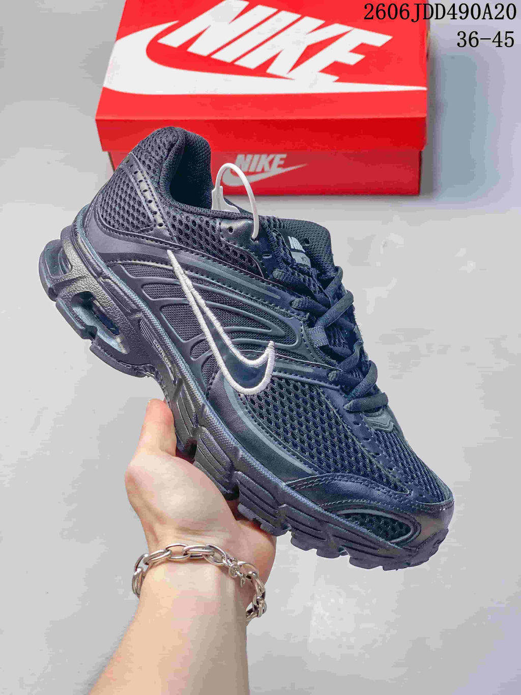 Dark charcoal Nike Air Max Moto 2K sneaker with a light Swoosh accent