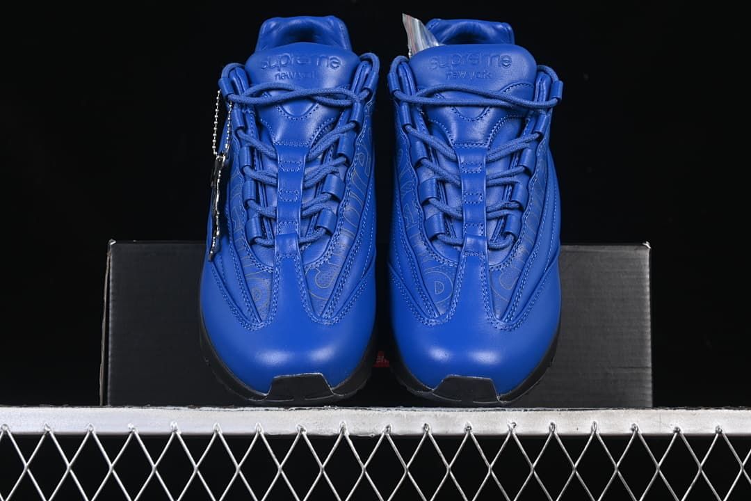 Front view of the pair showing blue uppers, laces, and Supreme tongue branding.