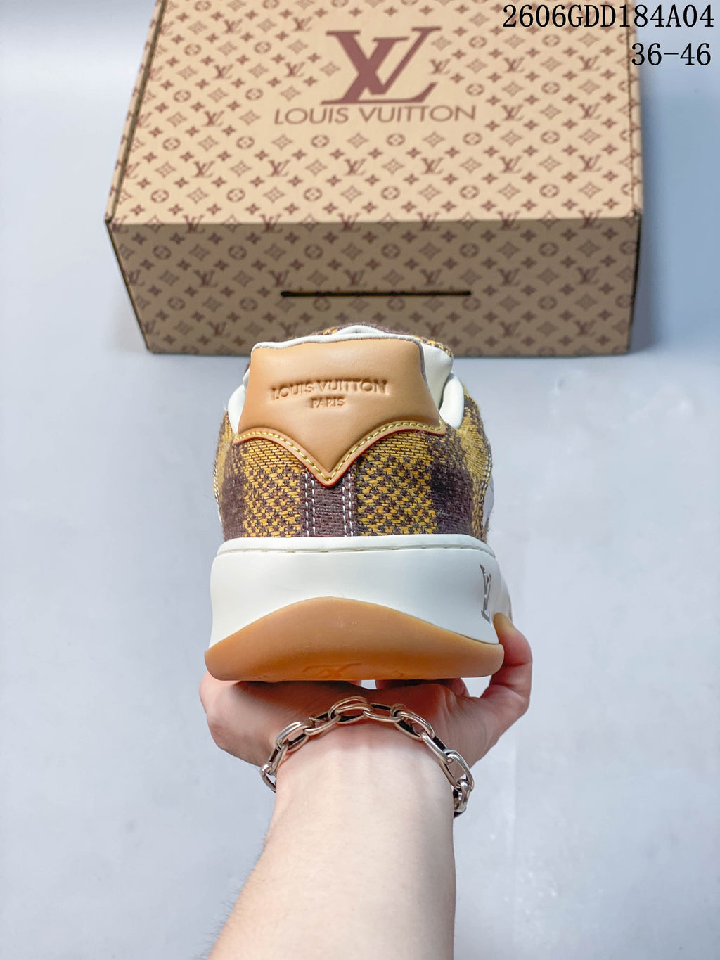 Rear view of the sneaker showing its check-pattern upper and tan heel tab