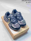 Pair of navy and silver ASICS GEL-NYC 2 sneakers displayed on a shoebox