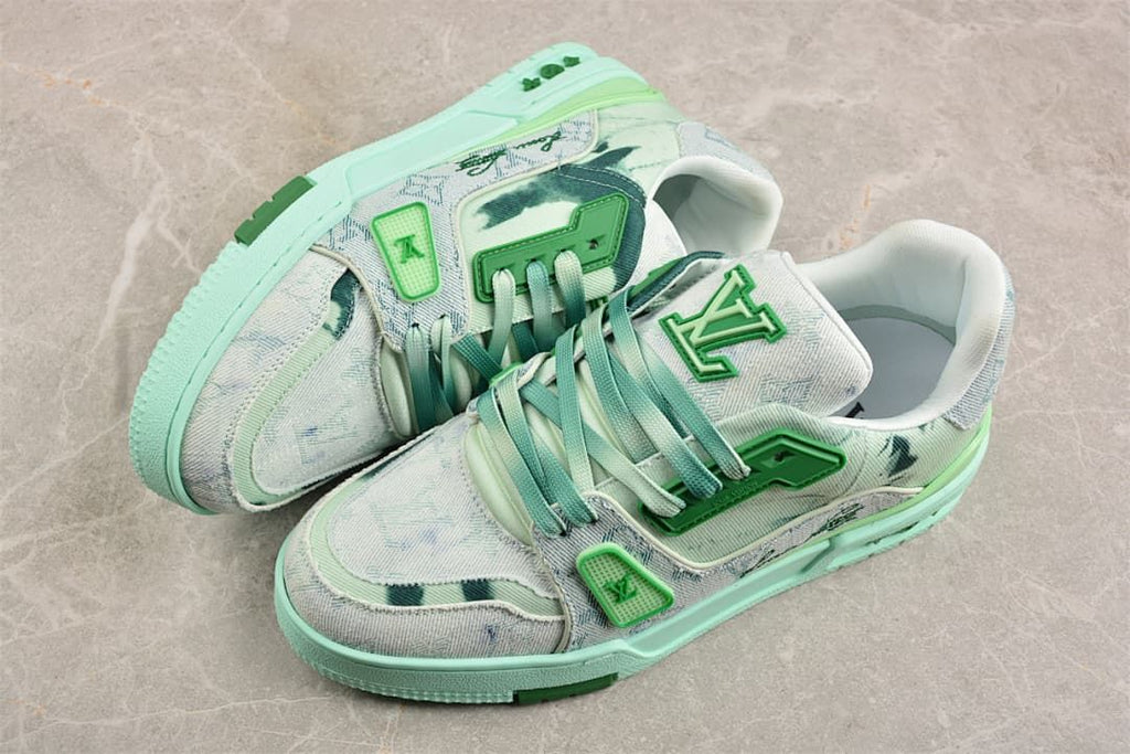 Pair of pale patterned sneakers with green laces and mint-colored soles.