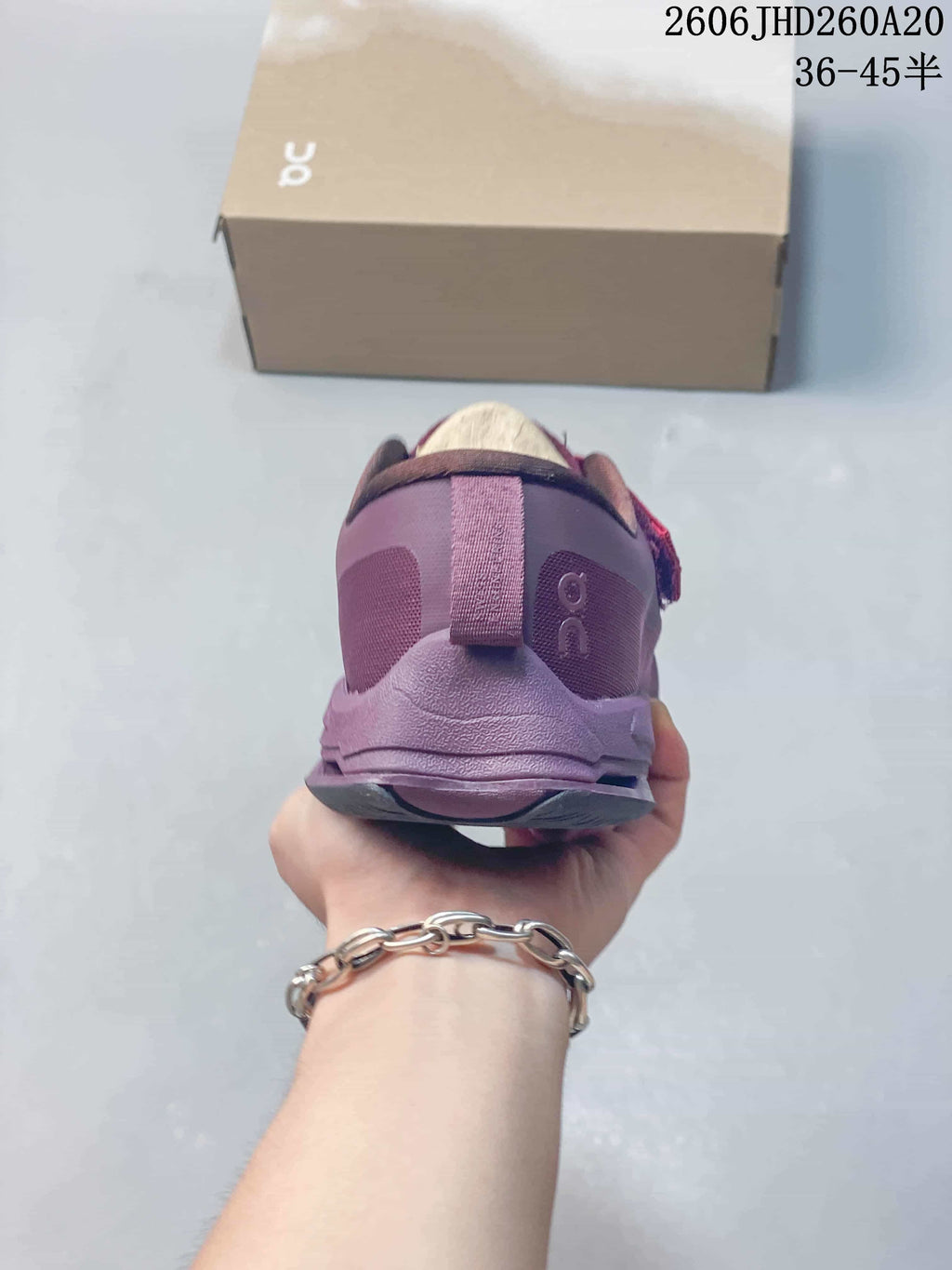Rear view of the purple shoe showing the heel pull tab and logo