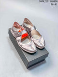 Pair of pink and metallic-toned Nike Air Rift shoes on a box