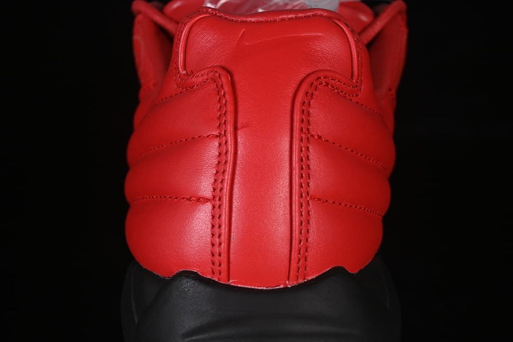 Rear view showing the red padded heel and black sole