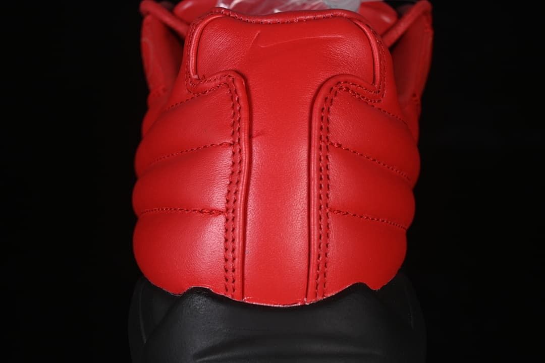 Rear view showing the red padded heel and black sole