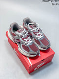 Pair of burgundy, silver, gray, and white Nike V5 RNR sneakers on a shoebox.