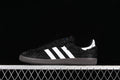 Side view of a black adidas Samba OG sneaker with white stripes and a dark outsole