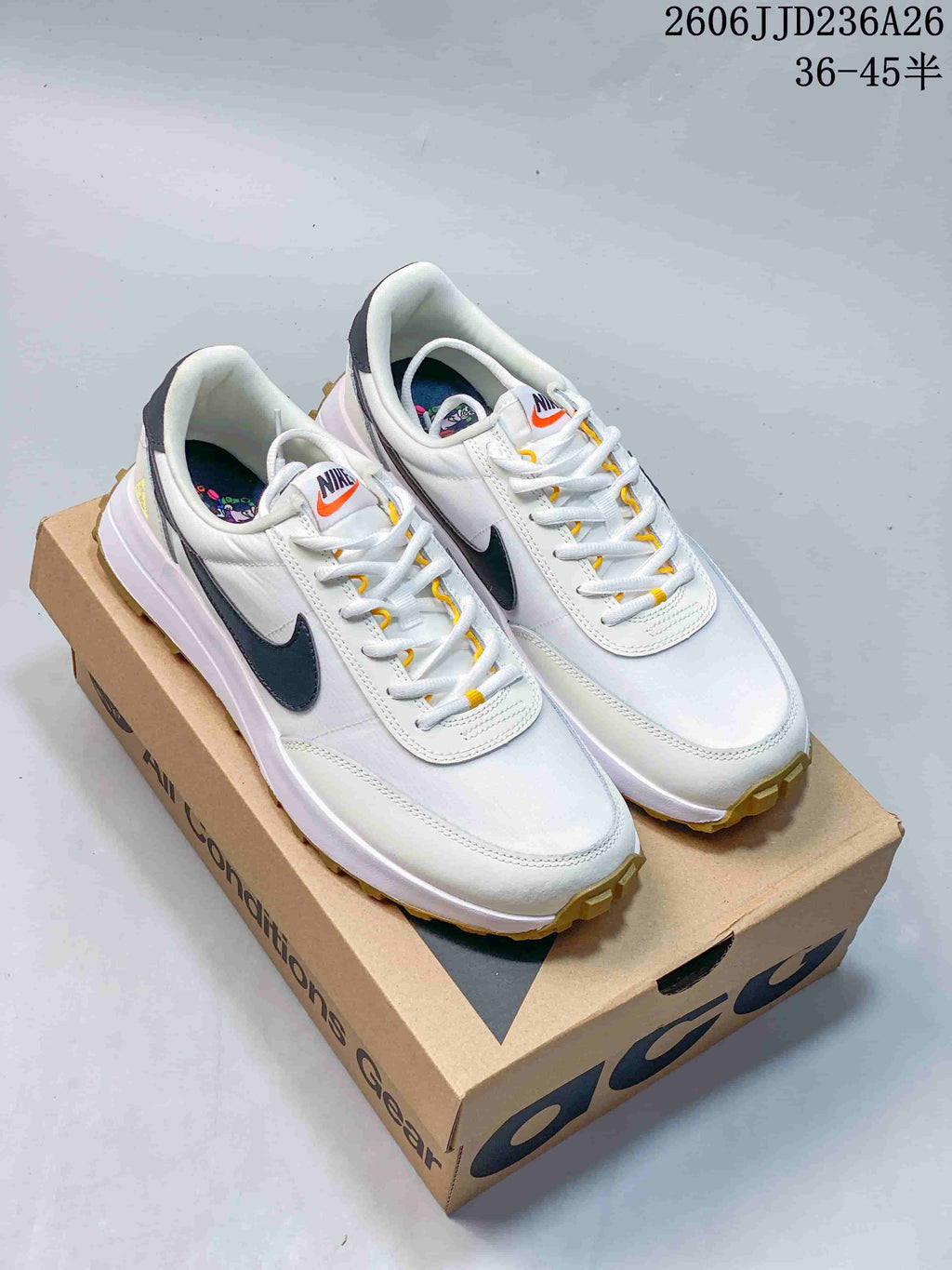 Pair of white Nike ACG LDV sneakers with dark Swoosh accents and gum-colored outsole details.