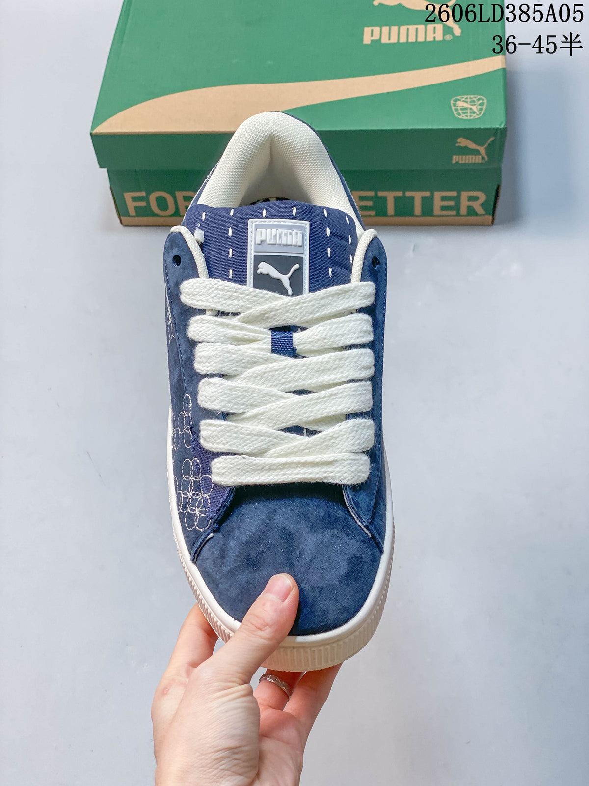 Top view of a blue PUMA sneaker with white laces and a branded tongue.