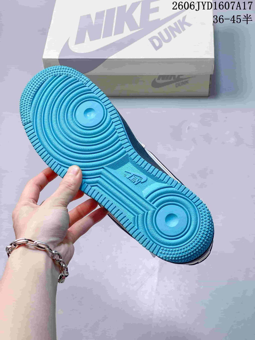 View of the turquoise outsole and circular tread pattern