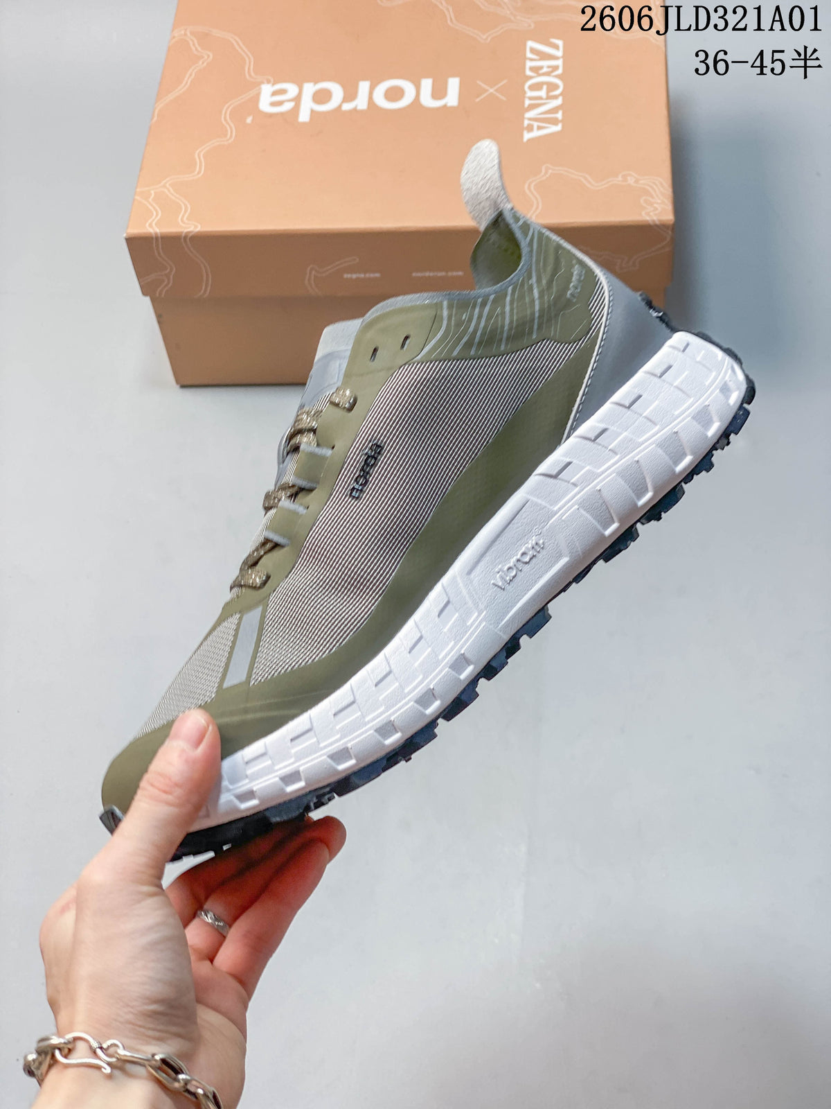 Side profile of the shoe with olive green and grey panels, a yellow-green accent, and a white midsole.